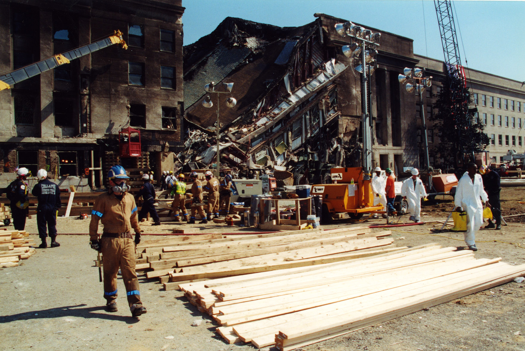 Rescue workers near a collapsed section of building